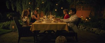 Movie still from “Puppy Love” (2023), directed by Richard Alan Reid – A group of people sitting at a table with food on it; Wide shot, High angle