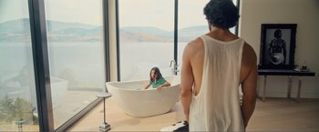 Movie still from “Puppy Love” (2023), directed by Richard Alan Reid – A woman sitting in a bathtub in front of a man; Wide shot, Over the shoulder angle