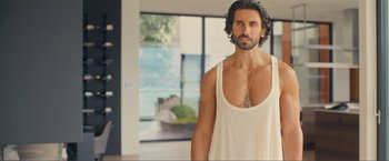 Movie still from “Puppy Love” (2023), directed by Richard Alan Reid – A person wearing a tank top; Medium shot, Over the shoulder angle