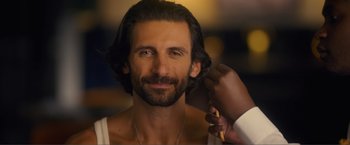 Movie still from “Puppy Love” (2023), directed by Richard Alan Reid – A man getting his hair combed by another man; Close Up shot, Over the shoulder angle