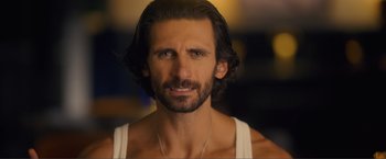 Movie still from “Puppy Love” (2023), directed by Richard Alan Reid – A person wearing a tank top; Close Up shot, Over the shoulder angle