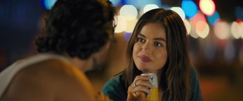 Movie still from “Puppy Love” (2023), directed by Richard Alan Reid – A woman holding a can of orange juice in front of a man; Close Up shot, Over the shoulder angle