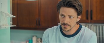 Movie still from “Puppy Love” (2023), directed by Richard Alan Reid – A person wearing a shirt; Close Up shot, Over the shoulder angle