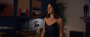 Movie still from “Puppy Love” (2023), directed by Richard Alan Reid – A beautiful young woman standing in a room; Medium shot, Over the shoulder angle