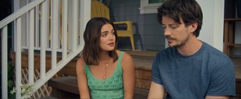 Movie still from “Puppy Love” (2023), directed by Richard Alan Reid – A woman sitting next to a man on a porch; Close Up shot, Over the shoulder angle