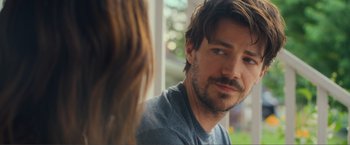 Movie still from “Puppy Love” (2023), directed by Richard Alan Reid – A person sitting in front of another person; Close Up shot, Over the shoulder angle