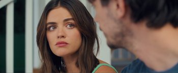 Movie still from “Puppy Love” (2023), directed by Richard Alan Reid – A person sitting down with another person; Close Up shot, Over the shoulder angle