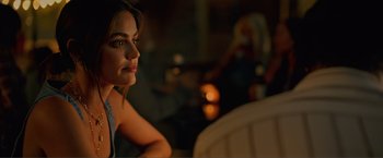 Movie still from “Puppy Love” (2023), directed by Richard Alan Reid – A woman sitting at a table in front of candles; Close Up shot, Over the shoulder angle