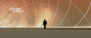 Movie still from “Quantum of Solace” (2008), directed by Marc Forster – A man is walking in front of an orange background; Extreme Wide shot, Low angle