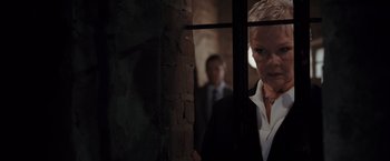 Movie still from “Quantum of Solace” (2008), directed by Marc Forster – A man and a woman standing next to each other in front of a window; Close Up shot, Low angle