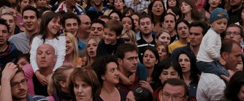 Movie still from “Quantum of Solace” (2008), directed by Marc Forster – A large group of people gathered together in a crowd; Medium shot, High angle