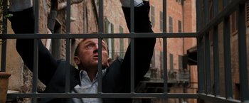 Movie still from “Quantum of Solace” (2008), directed by Marc Forster – A man standing in front of a jail cell; Medium shot, Low angle