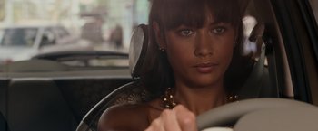 Movie still from “Quantum of Solace” (2008), directed by Marc Forster – A woman sitting in the driver's seat of a car; Close Up shot, High angle