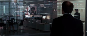 Movie still from “Quantum of Solace” (2008), directed by Marc Forster – A person is standing in front of a window; Medium shot, Over the shoulder angle