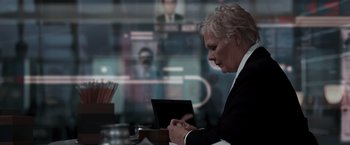 Movie still from “Quantum of Solace” (2008), directed by Marc Forster – An older woman is using a tablet computer; Close Up shot, Over the shoulder angle