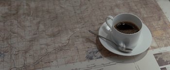 Movie still from “Quantum of Solace” (2008), directed by Marc Forster – A cup of coffee on a map; Extreme Close Up shot, High angle