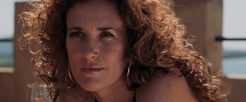 Movie still from “Quantum of Solace” (2008), directed by Marc Forster – A woman with curly hair; Close Up shot, Low angle