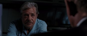 Movie still from “Quantum of Solace” (2008), directed by Marc Forster – An older man sitting in front of a window; Close Up shot, Over the shoulder angle