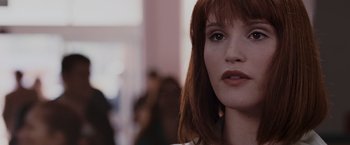 Movie still from “Quantum of Solace” (2008), directed by Marc Forster – A woman with red hair; Close Up shot, Over the shoulder angle