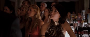 Movie still from “Quantum of Solace” (2008), directed by Marc Forster – A group of people sitting in front of each other; Close Up shot, Low angle