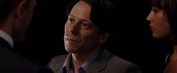 Movie still from “Quantum of Solace” (2008), directed by Marc Forster – A person wearing a suit and tie; Close Up shot, Low angle