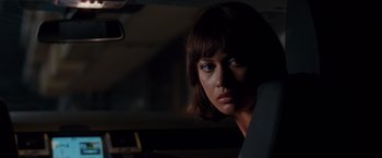 Movie still from “Quantum of Solace” (2008), directed by Marc Forster – A woman sitting in the back seat of a car; Close Up shot, Over the shoulder angle