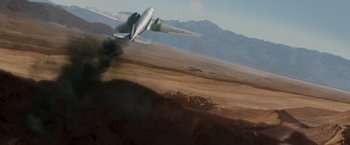 Movie still from “Quantum of Solace” (2008), directed by Marc Forster – An air plane with smoke coming out of the back of it; Extreme Wide shot, Low angle