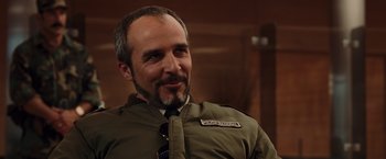 Movie still from “Quantum of Solace” (2008), directed by Marc Forster – A person wearing a jacket and a tie; Close Up shot, Over the shoulder angle