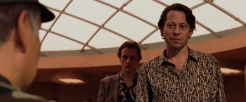 Movie still from “Quantum of Solace” (2008), directed by Marc Forster – Two men standing next to each other in front of a building; Close Up shot, Low angle