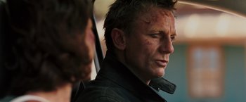 Movie still from “Quantum of Solace” (2008), directed by Marc Forster – A person wearing a black jacket; Close Up shot, Over the shoulder angle