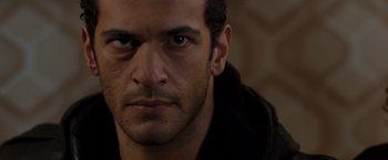 Movie still from “Quantum of Solace” (2008), directed by Marc Forster – A man's face with a serious look on his face; Close Up shot, Low angle