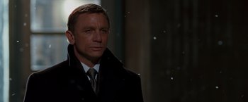 Movie still from “Quantum of Solace” (2008), directed by Marc Forster – A person wearing a suit and tie; Close Up shot, Low angle