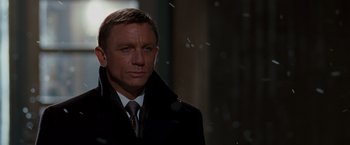 Movie still from “Quantum of Solace” (2008), directed by Marc Forster – A person wearing a suit and tie; Close Up shot, Low angle