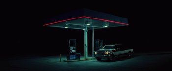 Movie still from “Queen & Slim” (2019), directed by Melina Matsoukas – A car parked in front of a gas station at night; Extreme Wide shot, Low angle