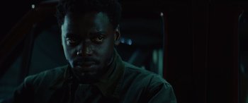 Movie still from “Queen & Slim” (2019), directed by Melina Matsoukas – A person wearing a green shirt; Close Up shot, Low angle