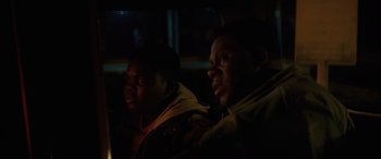 Movie still from “Queen & Slim” (2019), directed by Melina Matsoukas – Two men sitting next to each other in the dark; Close Up shot, Over the shoulder angle