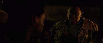 Movie still from “Queen & Slim” (2019), directed by Melina Matsoukas – A man in a green jacket is looking at another man in a green jacket; Close Up shot, Over the shoulder angle