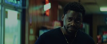 Movie still from “Queen & Slim” (2019), directed by Melina Matsoukas – A person wearing a black t - shirt; Close Up shot, Over the shoulder angle