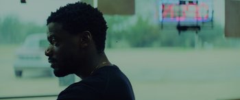Movie still from “Queen & Slim” (2019), directed by Melina Matsoukas – A young man sitting in front of a window; Close Up shot, Over the shoulder angle