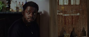 Movie still from “Queen & Slim” (2019), directed by Melina Matsoukas – A person wearing a necklace; Close Up shot, Over the shoulder angle