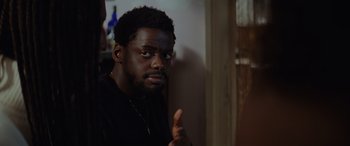 Movie still from “Queen & Slim” (2019), directed by Melina Matsoukas – A man with a beard is looking at the camera; Close Up shot, Over the shoulder angle