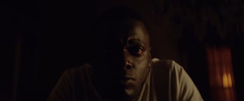 Movie still from “Queen & Slim” (2019), directed by Melina Matsoukas – A person's face in the dark; Close Up shot, High angle