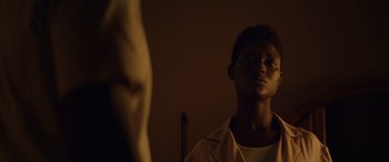 Movie still from “Queen & Slim” (2019), directed by Melina Matsoukas – A young man looking into a mirror in the dark; Close Up shot, Low angle