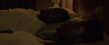 Movie still from “Queen & Slim” (2019), directed by Melina Matsoukas – A man laying in a bed looking up at the sky; Close Up shot, Overhead angle