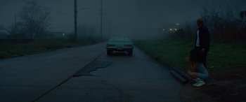 Movie still from “Queen & Slim” (2019), directed by Melina Matsoukas – A car parked on the side of the road in the dark; Extreme Wide shot, Low angle