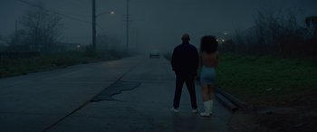 Movie still from “Queen & Slim” (2019), directed by Melina Matsoukas – A man and a woman standing on the side of a road; Wide shot, Low angle