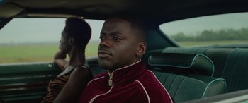 Movie still from “Queen & Slim” (2019), directed by Melina Matsoukas – A man sitting in the back seat of a car; Close Up shot, Over the shoulder angle