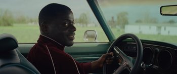 Movie still from “Queen & Slim” (2019), directed by Melina Matsoukas – A man sitting in the driver's seat of a car; Close Up shot, Over the shoulder angle