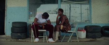 Movie still from “Queen & Slim” (2019), directed by Melina Matsoukas – A man and a woman sitting next to each other on chairs; Medium shot, Over the shoulder angle