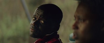 Movie still from “Queen & Slim” (2019), directed by Melina Matsoukas – A person wearing a red shirt; Close Up shot, Over the shoulder angle